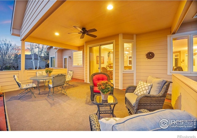 view of patio with an outdoor living space, outdoor dining area, and ceiling fan
