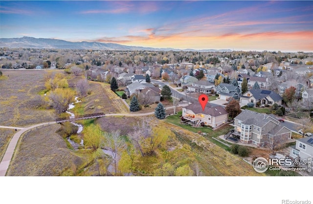 drone / aerial view featuring a residential view and a mountain view