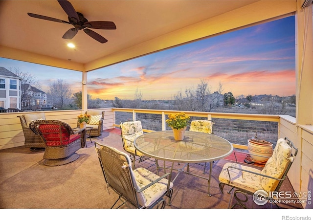 patio terrace at dusk with a ceiling fan and outdoor dining area