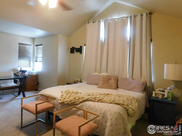 carpeted bedroom with vaulted ceiling and ceiling fan