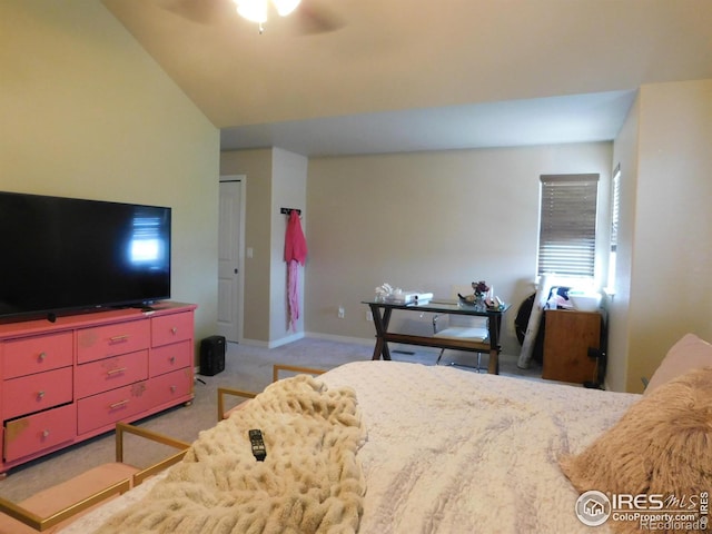bedroom featuring light colored carpet, a ceiling fan, vaulted ceiling, and baseboards