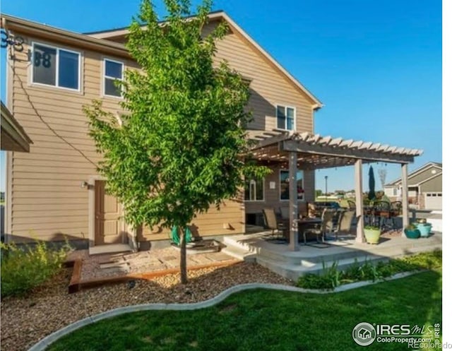 back of property featuring a pergola and a patio