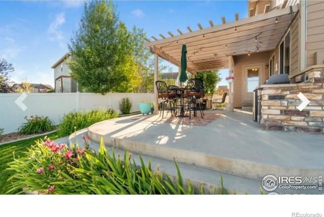 view of patio featuring fence
