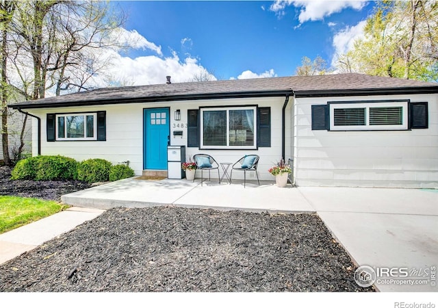 single story home with roof with shingles