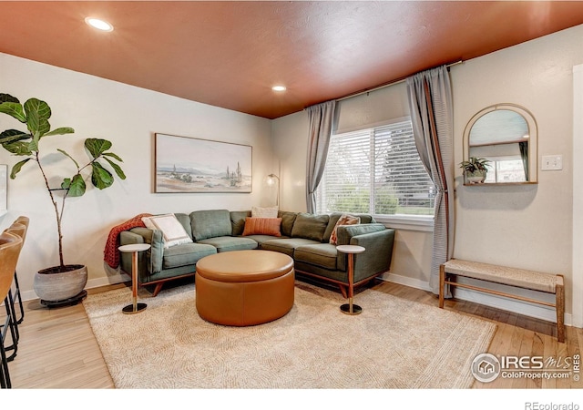 living room with baseboards, recessed lighting, and wood finished floors