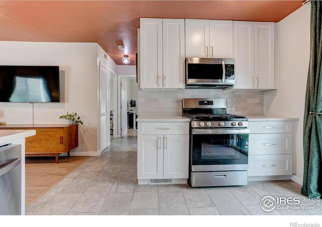 kitchen with light countertops, appliances with stainless steel finishes, and backsplash