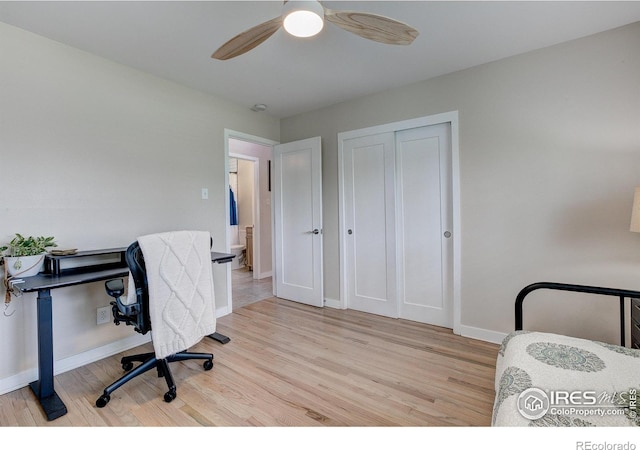 office area featuring baseboards, a ceiling fan, and wood finished floors