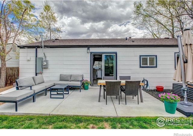 rear view of property featuring an outdoor living space, fence, and a patio