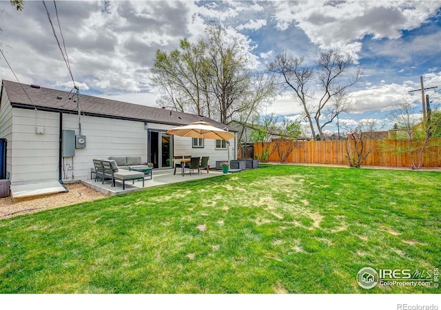 view of yard with a patio, an outdoor living space, and a fenced backyard