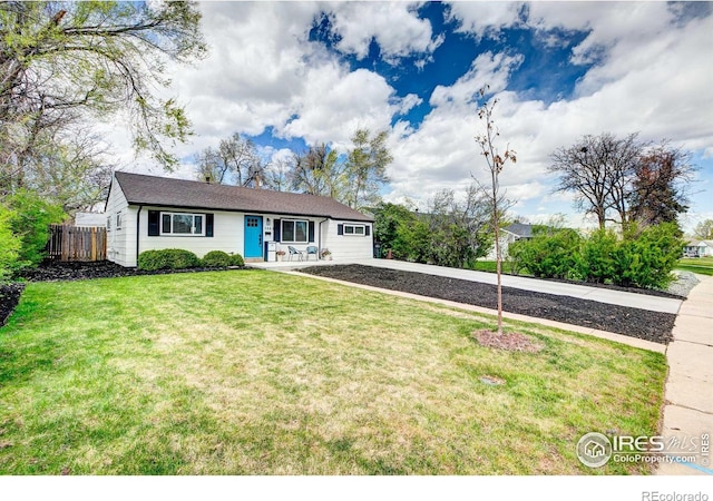 ranch-style house featuring fence, driveway, and a front yard