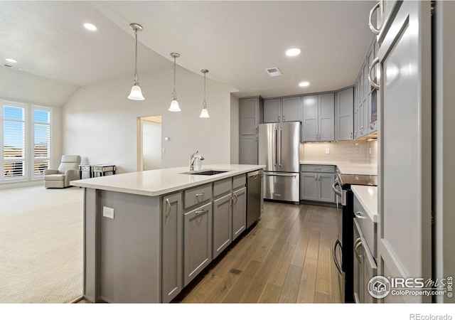 2751 Iowa Dr Unit 305, Fort Collins, CO 80525 - kitchen featuring appliances with stainless steel finishes, gray cabinets, a sink, lofted ceiling, and a kitchen island with sink