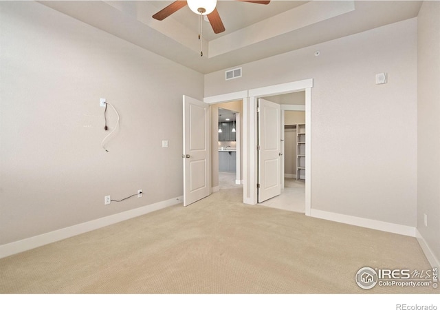 2751 Iowa Dr Unit 305, Fort Collins, CO 80525 - unfurnished bedroom with light carpet, a raised ceiling, baseboards, a spacious closet, and a ceiling fan