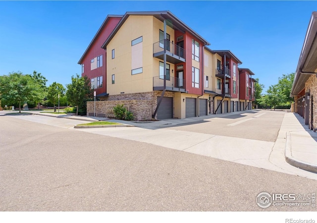 2751 Iowa Dr Unit 305, Fort Collins, CO 80525 - view of building exterior with an attached garage