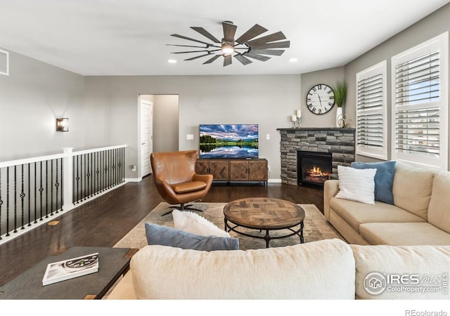 2121 Covered Bridge Pkwy, Windsor, CO 80550 - living room featuring ceiling fan, a fireplace, wood finished floors, baseboards, and recessed lighting
