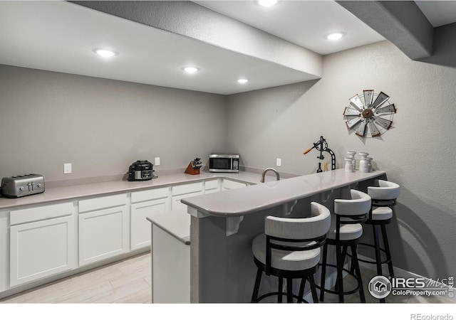 2121 Covered Bridge Pkwy, Windsor, CO 80550 - bar featuring a toaster, stainless steel microwave, and recessed lighting