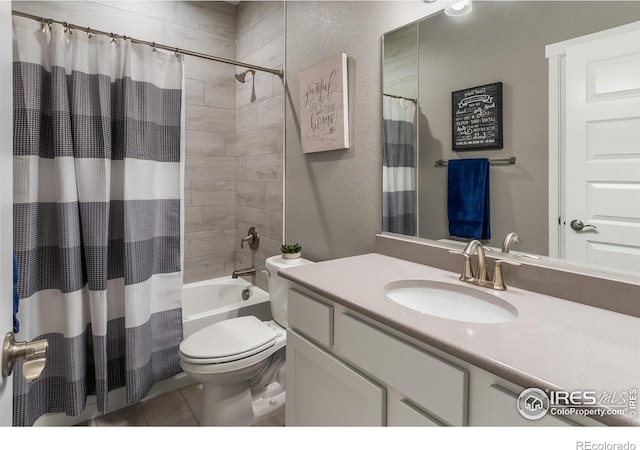 2121 Covered Bridge Pkwy, Windsor, CO 80550 - bathroom with a textured wall, vanity, toilet, tile patterned floors, and shower / tub combo