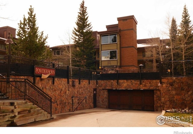 755 Columbine Rd Unit 303, Breckenridge, CO 80424 - view of building exterior with a garage and concrete driveway