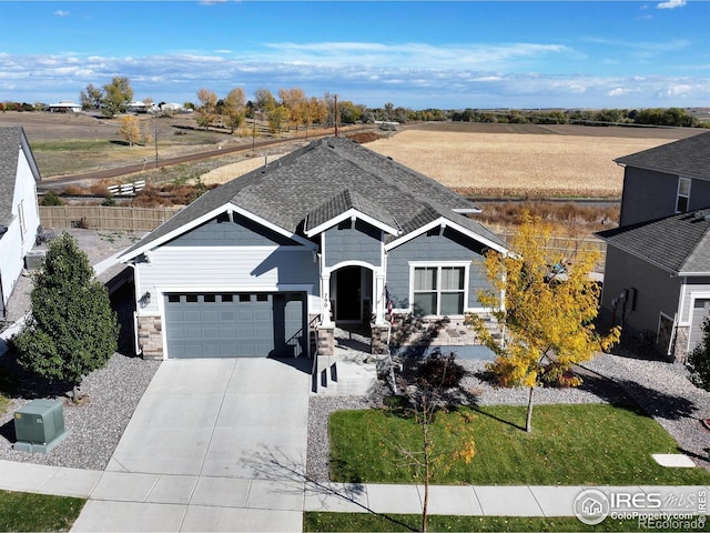 single story home featuring an attached garage, driveway, and stone siding