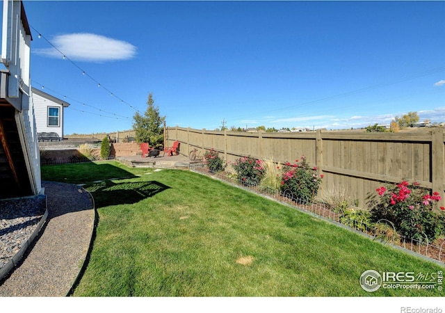 view of yard with a fenced backyard