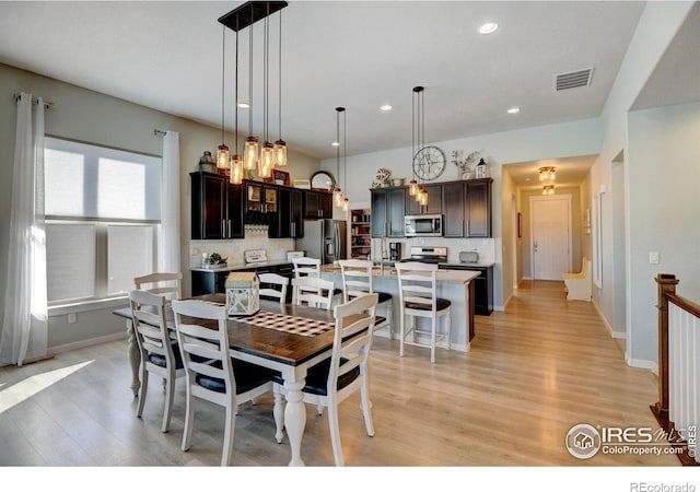 dining area with visible vents, recessed lighting, light wood-style flooring, and baseboards