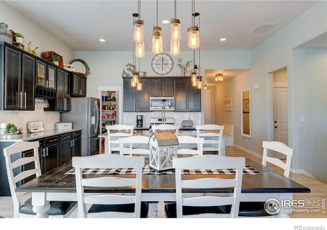 dining area with visible vents, recessed lighting, light wood finished floors, and baseboards