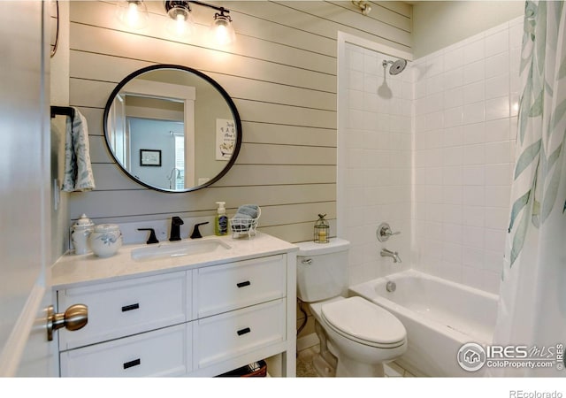 bathroom featuring vanity, wood walls, toilet, and shower / bathtub combination with curtain
