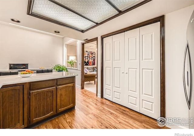 15503 E Wyoming Dr Unit G, Aurora, CO 80017 - kitchen with light wood-style floors, arched walkways, and light countertops