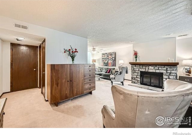 15503 E Wyoming Dr Unit G, Aurora, CO 80017 - living area with light colored carpet, a textured ceiling, ceiling fan, and a fireplace