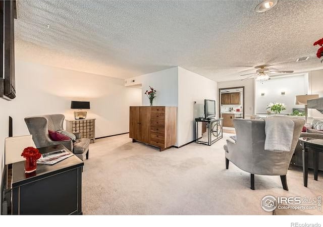 15503 E Wyoming Dr Unit G, Aurora, CO 80017 - living room with a ceiling fan, light colored carpet, and a textured ceiling