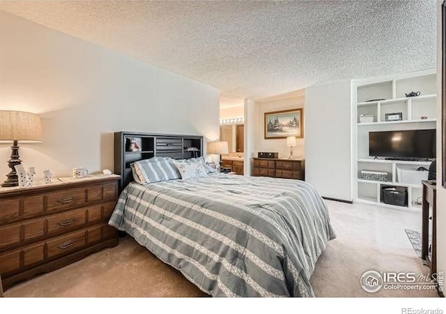 15503 E Wyoming Dr Unit G, Aurora, CO 80017 - bedroom featuring light colored carpet and a textured ceiling
