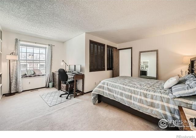 15503 E Wyoming Dr Unit G, Aurora, CO 80017 - bedroom featuring carpet flooring, a textured ceiling, and an office area