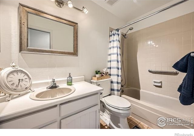 15503 E Wyoming Dr Unit G, Aurora, CO 80017 - full bathroom featuring vanity, shower / bath combo with shower curtain, and toilet