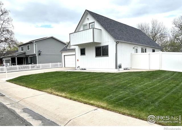 425 Stanford St, Brush, CO 80723 - rear view of property featuring a garage, a shingled roof, and driveway