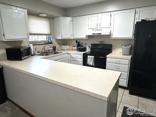 425 Stanford St, Brush, CO 80723 - kitchen featuring black appliances, under cabinet range hood, a sink, a peninsula, and light countertops