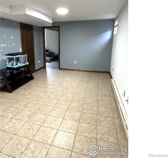 425 Stanford St, Brush, CO 80723 - unfurnished living room featuring a baseboard heating unit and light tile patterned floors