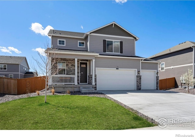 3759 Catmint St, Wellington, CO 80549 - view of front of home with fence, covered porch, stone siding, a front yard, and driveway