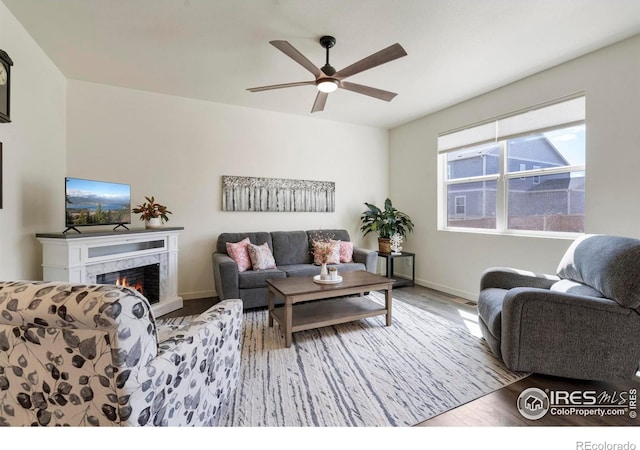 3759 Catmint St, Wellington, CO 80549 - living area featuring baseboards, ceiling fan, wood finished floors, and a high end fireplace