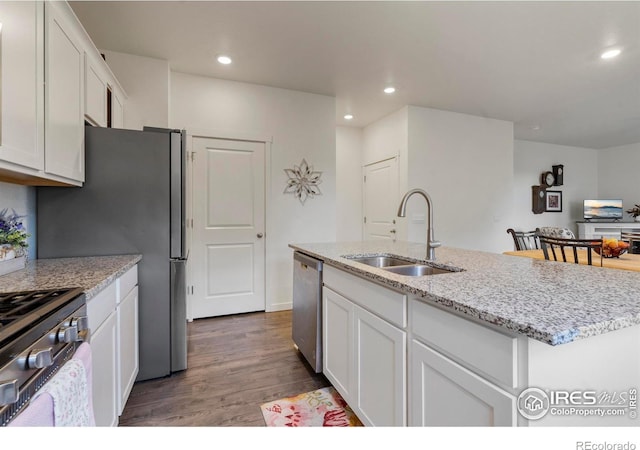 3759 Catmint St, Wellington, CO 80549 - kitchen with a sink, stainless steel appliances, dark wood finished floors, and white cabinetry