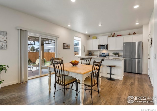 3759 Catmint St, Wellington, CO 80549 - dining room featuring dark wood-type flooring, recessed lighting, and baseboards