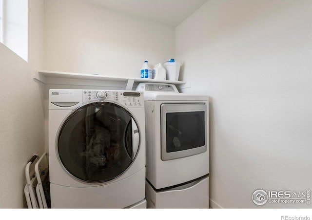 3759 Catmint St, Wellington, CO 80549 - washroom featuring laundry area, radiator heating unit, and washer and dryer