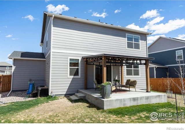 3759 Catmint St, Wellington, CO 80549 - back of house featuring a lawn, fence, and a patio area