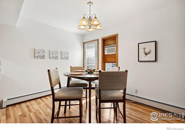 4560 Larkbunting Dr Unit 2B, Fort Collins, CO 80526 - dining space featuring a baseboard radiator, a chandelier, and light wood-type flooring