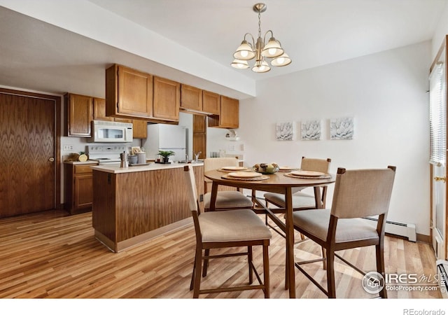 4560 Larkbunting Dr Unit 2B, Fort Collins, CO 80526 - kitchen featuring white appliances, light wood-style flooring, baseboard heating, and a chandelier