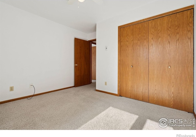 4560 Larkbunting Dr Unit 2B, Fort Collins, CO 80526 - unfurnished bedroom featuring carpet flooring, a closet, baseboards, and a ceiling fan