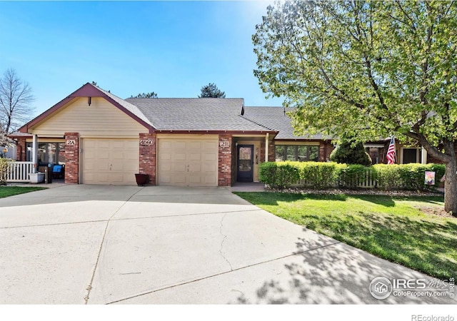 4560 Larkbunting Dr Unit 2B, Fort Collins, CO 80526 - view of front of property with a garage, driveway, brick siding, a front lawn, and roof with shingles