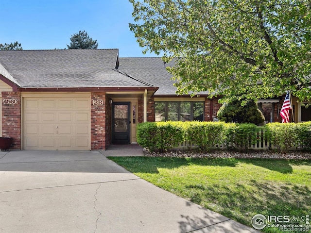 4560 Larkbunting Dr Unit 2B, Fort Collins, CO 80526 - view of front of property with a garage, driveway, brick siding, a front yard, and roof with shingles