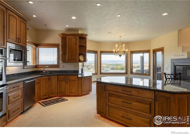 kitchen with brown cabinetry, open shelves, a notable chandelier, stainless steel appliances, and recessed lighting