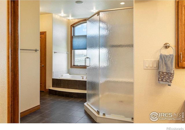 bathroom with a garden tub, tile patterned flooring, and a stall shower