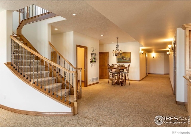 interior space featuring visible vents, an inviting chandelier, stairs, baseboards, and recessed lighting