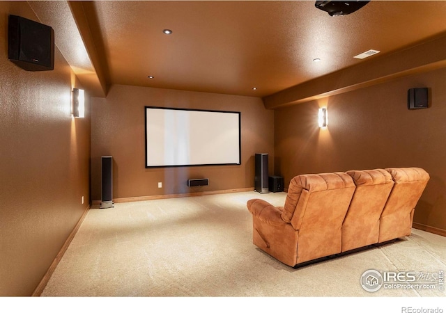 carpeted cinema with visible vents and baseboards
